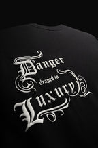 DANGER DRAPED IN LUXURY TEE