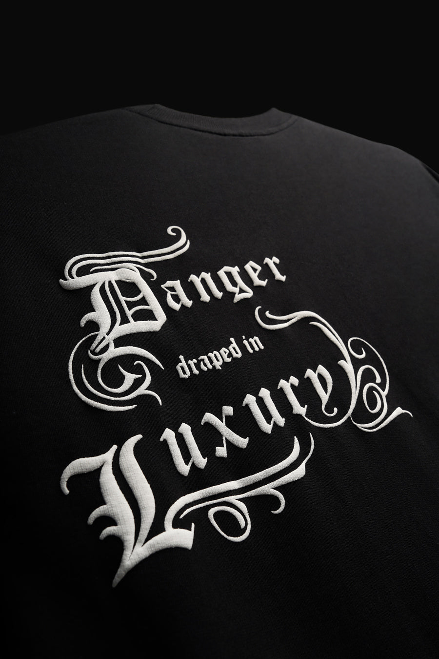 DANGER DRAPED IN LUXURY TEE